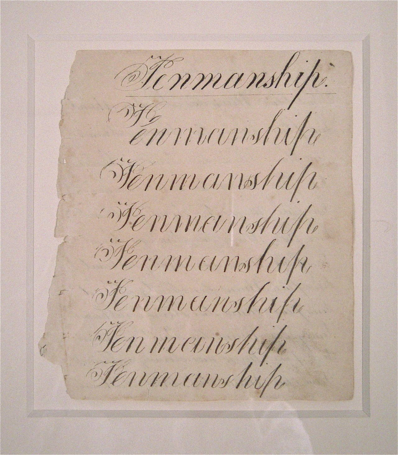 A 19th century pen and ink on paper calligraphy exercise, circa 1840s, which demonstrates the student's practicing  the word 'penmanship' in florid script on 8 lines. Newly, archivally framed, matte floated with 8ply acid free matte, and UV