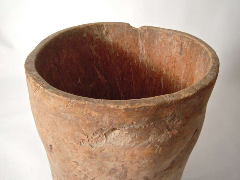 A beautiful, early country grain storage barrel made from a completely hollowed tree trunk, possibly hornbeam or sycamore, with wonderful dry surface, texture and form, the bottom attached with early wrought iron nails.

Height: 31