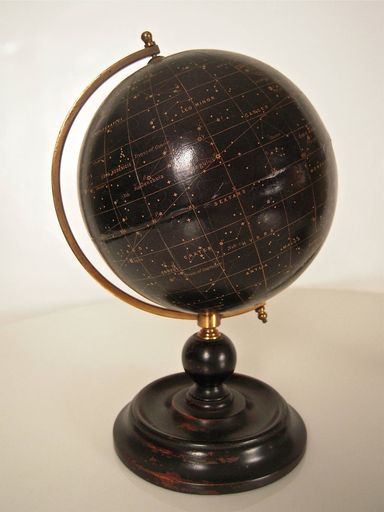 An unusual pair of small English, 6 inch celestial and terrestrial globes by George Philip & Son, London, early 20th century, both with twelve colored printed gores, uncalibrated lacquered brass half meridian ring, resting on similar ebonized