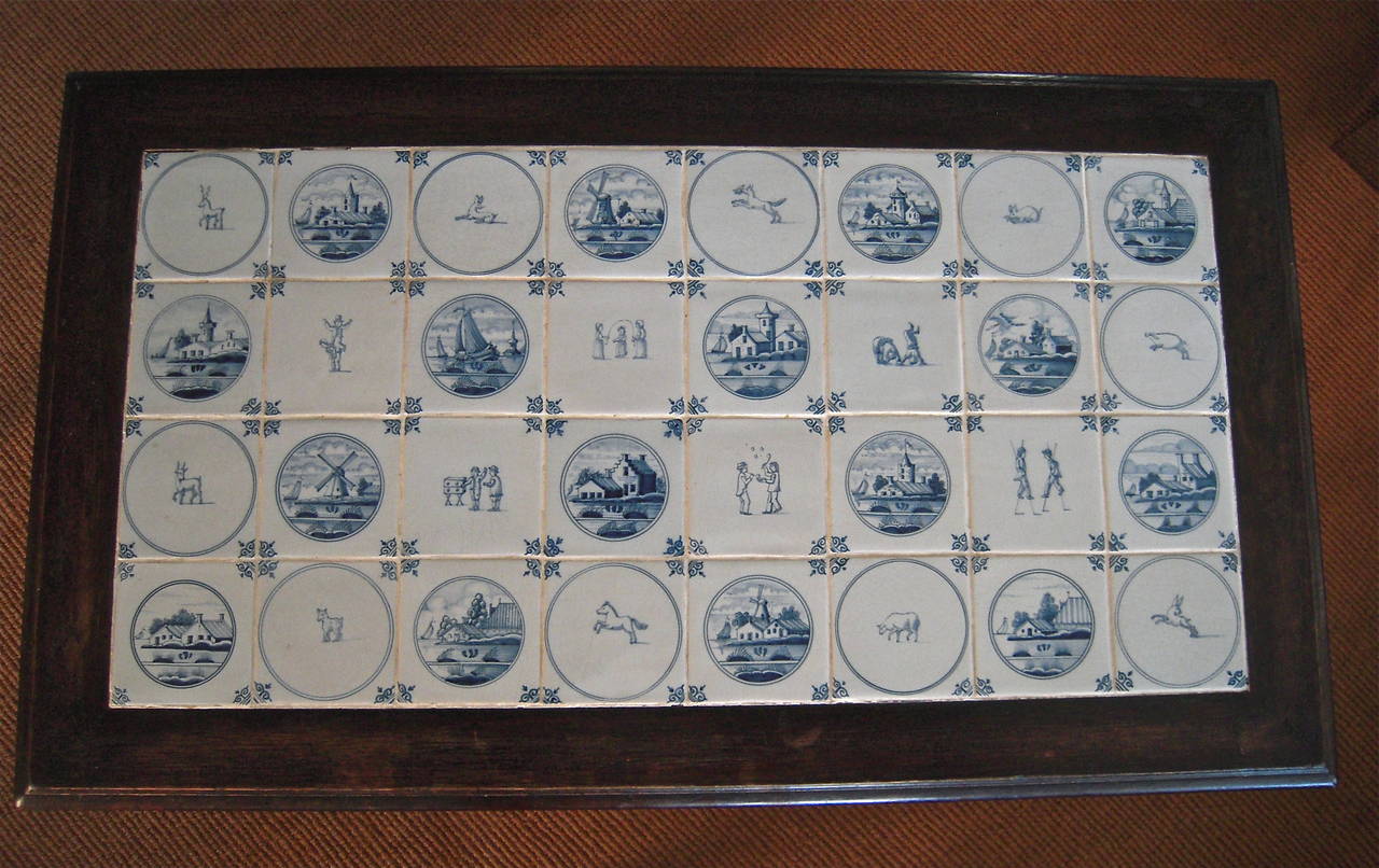 A fine quality, beautifully made Dutch Baroque style table in dark stained oak, with blue and white Delft tiles, depicting animals, people and buildings, inset into the rectangular top, supported by beautifully turned barley twist legs joined by