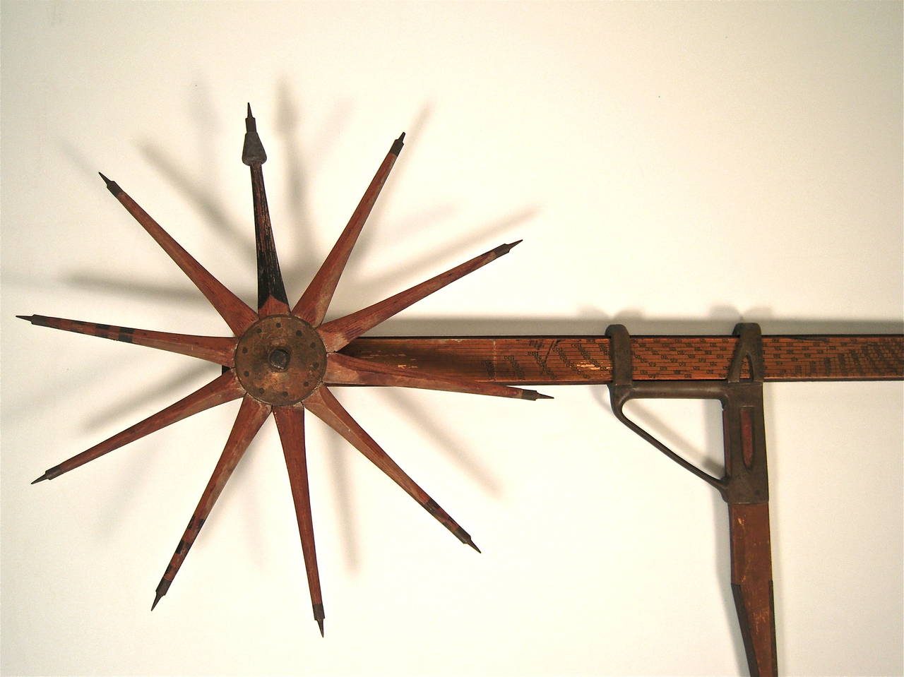 A beautifully made log caliper and rule, with weighted walking wheel and incised  intricately detailed numbered ruler, with  sliding metal gage, made by Florence M. Greenleaf, Littleton, New Hampshire (signed), circa 1916-1922, the wheel possibly