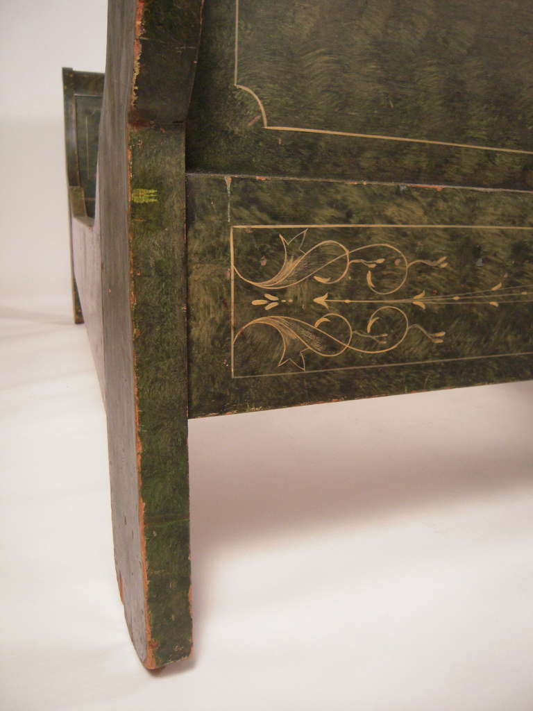 An American Neoclassical green painted sleigh bed, with white painted pinstripe and bird decoration on the head and foot boards and rails, circa 1820-40. Full or Double sized.

Height: 37