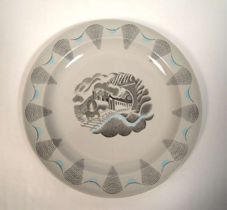 A rare Eric Ravilious designed Travel Series plate, designed c. 1938, and manufactured by Wedgwood, circa 1954, with black transfer printed decoration and painted light blue highlights on Windsor grey ground, featuring a locomotive traveling under