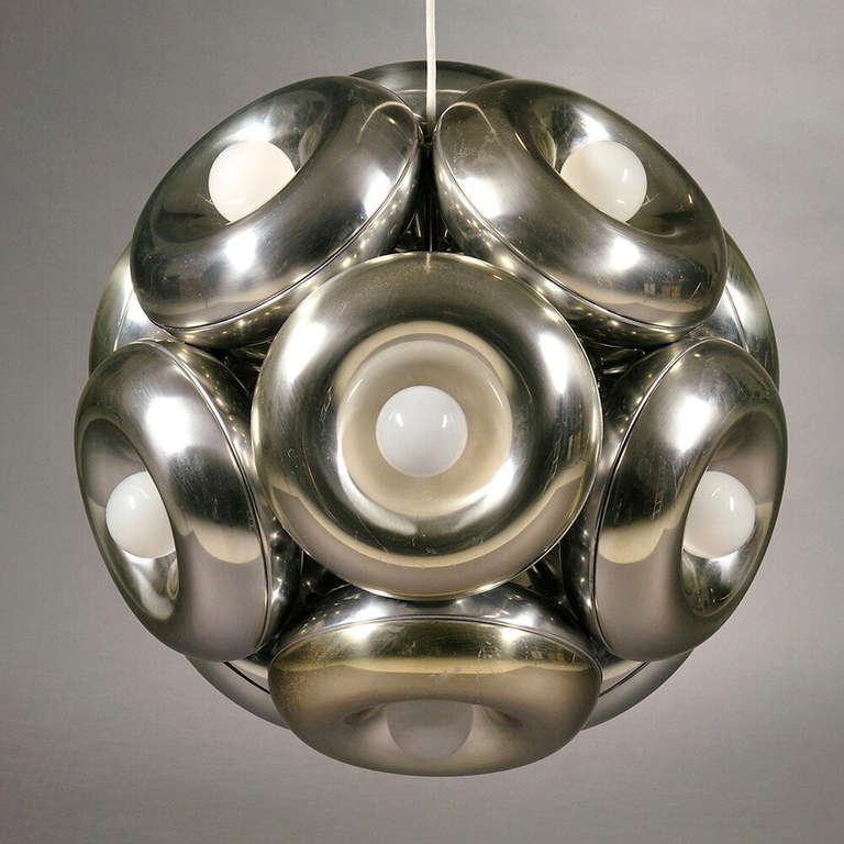 An unusual and sculptural hanging globe chandelier composed of twelve doughnut rings in aluminum, lined in white ceramic each centered by a single socket with bulb.