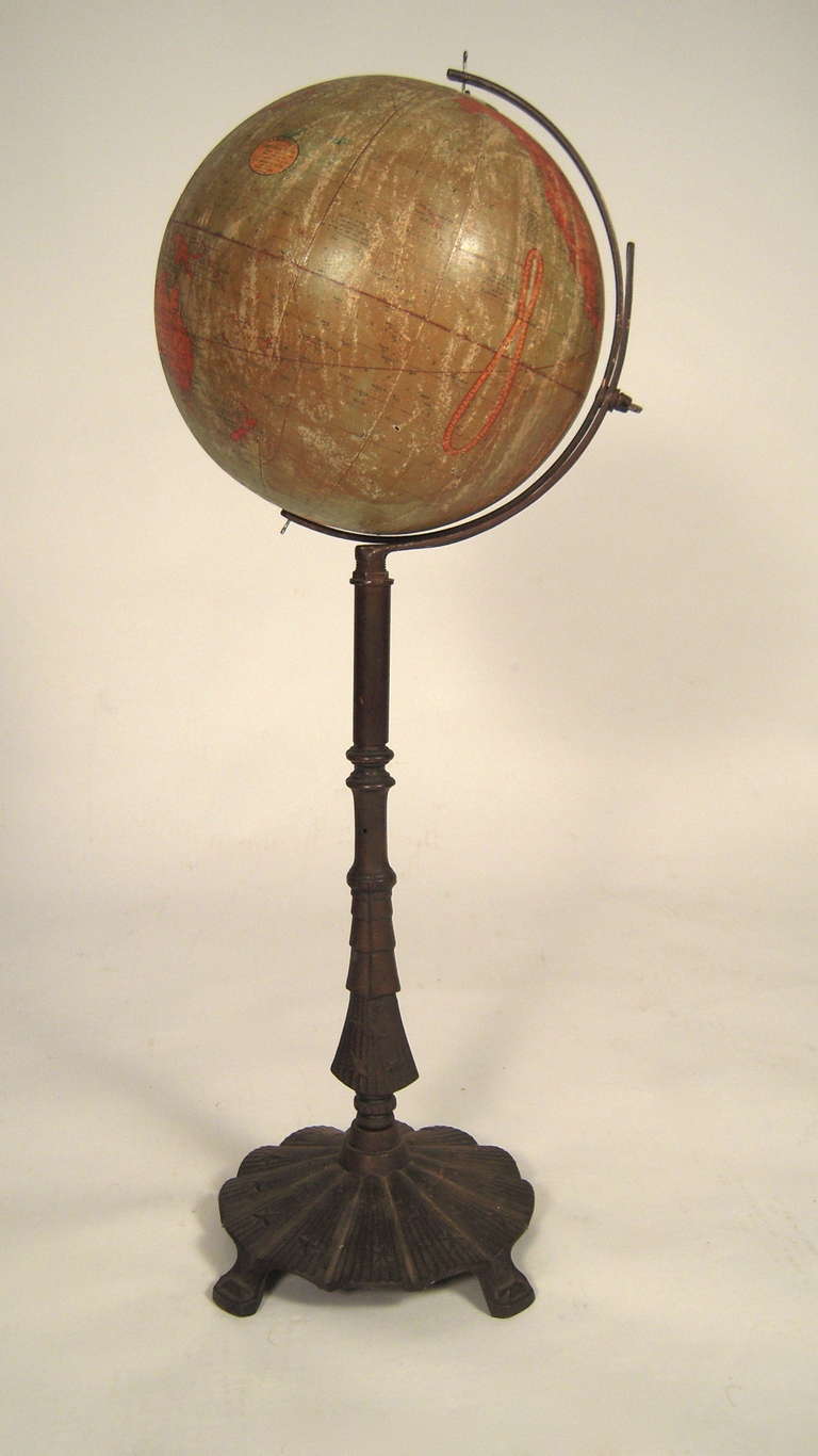 A decorative C.S. Hammond world globe on cast iron stand with fluted, scalloped circular base decorated with raised stars.