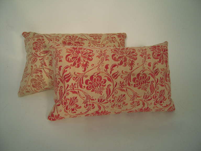 An antique red and buttery cream Fortuny fabric rectangular pillows, down filled and backed with cotton blend, in a beautiful, variegated floral and foliate pattern.