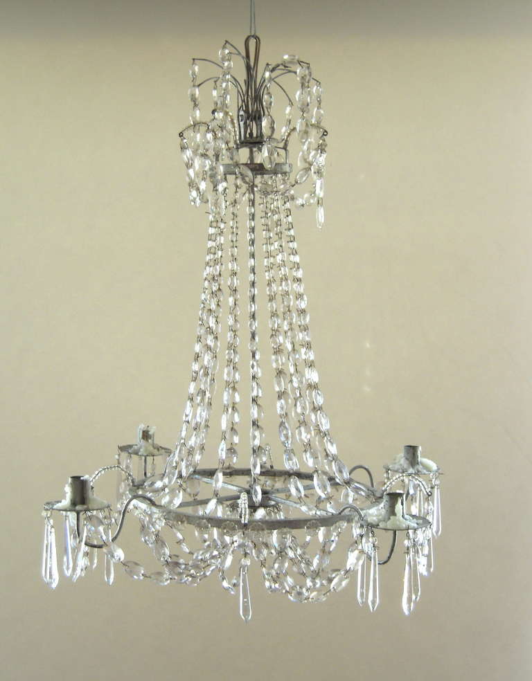An elegant, small neoclassical Swedish Gustavian style crystal chandelier, with silvered iron frame and four candle arms.