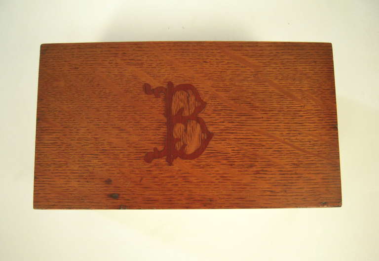 A 19th century rectangular box in golden oak, inlaid with a darker oak 'B' in an old English type font, similar to that used by today's Boston Red Sox. The interior of the box has gold edges and is newly lined with red felt.
