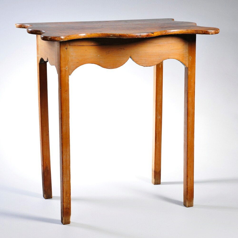 A late 18th-early 19th century American country pine serving table, the boldly shaped serpentine-edged top, over cyma-curved apron and sides, raised on four square section legs, circa 1790-1810. Wonderful height, perfect for a serving table or