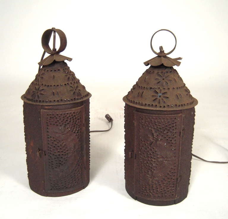 A pair of punched Tin Lanterns with wall brackets for hanging.
May also be ceiling mounted from loop on top.

Primarily useful as down lighting and ambient lighting, when  turned on, these lanterns cast a wonderful, 'stardust'