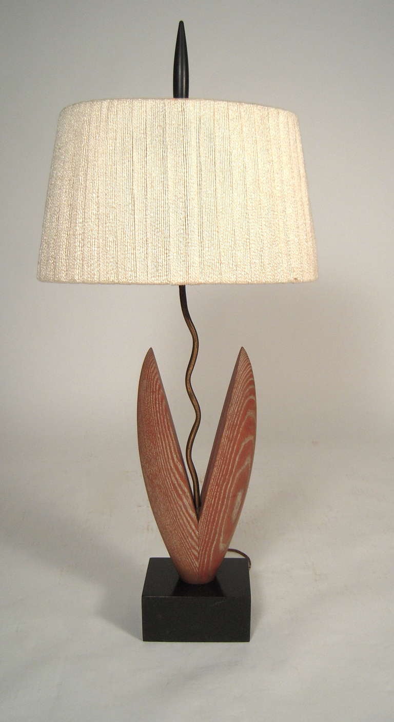 A 'Tulip' lamp, in cerused oak, brass and ebonized wood by Heifetz,  American, circa 1950s. Signed on base. With original turned wood finial.

Height:    47 3/4
