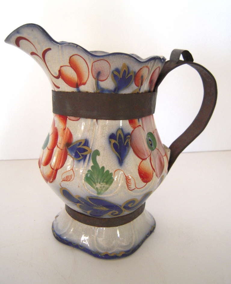 A 19th century hand-painted Staffordshire gaudy Welsh pitcher with wonderful, make do replaced tin handle.
Objects that feature 'make do' repairs, like this pitcher, are prized among collectors who appreciate the resourcefulness and ingenuity of