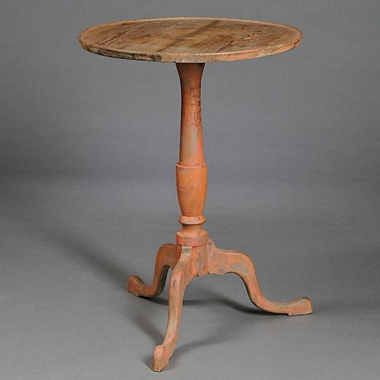 A beautifully colored American Federal period salmon painted candle stand occasional table in hard pine, circa 1790, the circular molded top supported by a vase and ring turned support on tripod cabriole leg base with pad feet.

Stabie, very