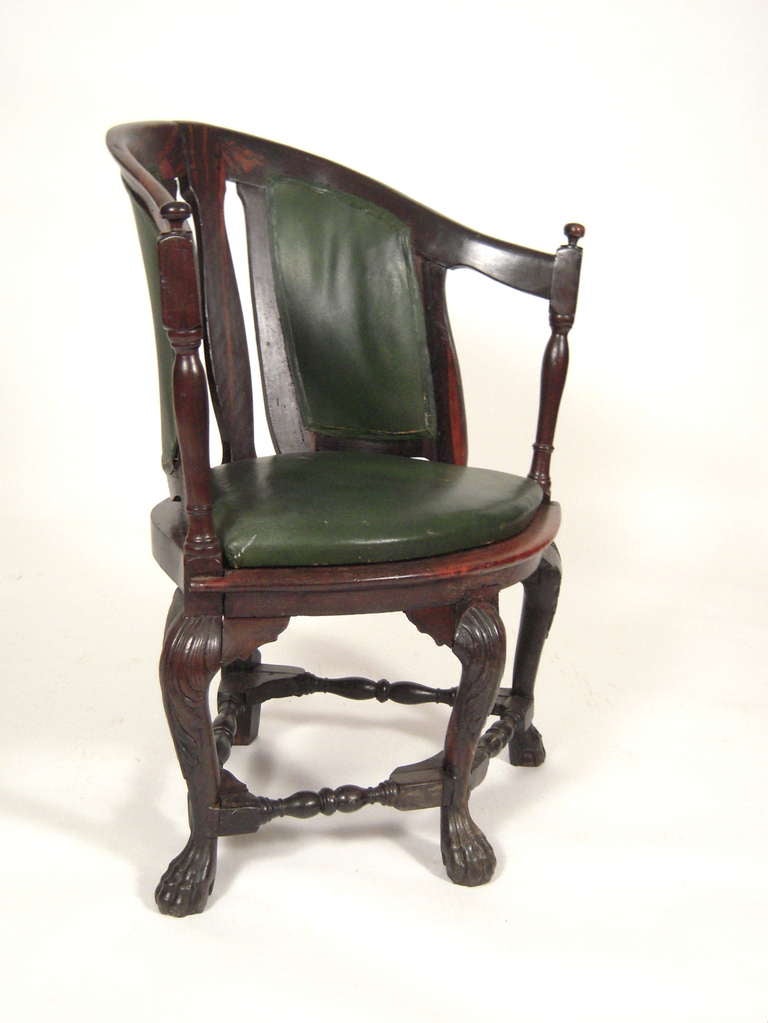 An 18th Century Portuguese Colonial Trade armchair in rosewood, likely Indo-Portuguese (Goa). Originally with caned back and seat; now with green leather upholstery.

Provenance: John Cottrell, Stillington Hall, Gloucester, Massachusetts