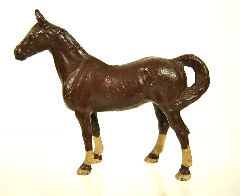 A painted heavy cast iron doorstop in the form of a horse, made by Hubley of Lancaster, Pennsylvania, circa 1920-1948, in brown paint with cream markings on head, ankles and feet.

Height: 10 1/2