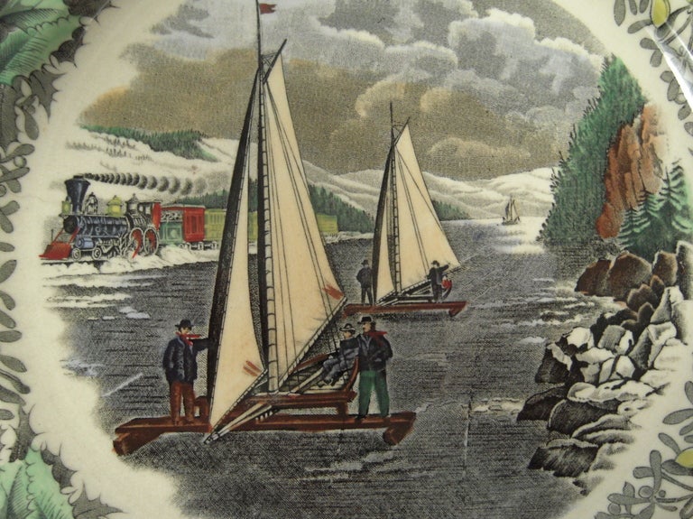 A Staffordshire transfer-printed plate centered by an N. Currier print entitled' Ice-Boat Race on the Hudson', colored in black and white with green, yellow, tan, blue and brown, from the 'Winter Scenes' series, depicting a procession of manned ice