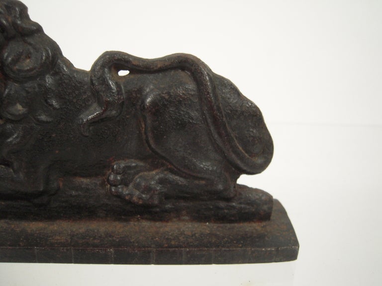 A 19th century cast iron doorstop in the form of a recumbent lion.