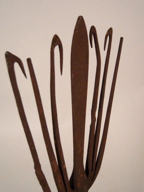 A 19th Century American wrought iron eel or  fishing spear ('gig'), newly mounted on an ebonized wood base. 
