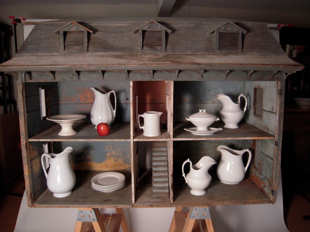 A giant 19th century American Victorian doll house of extraordinary scale and presence with original painted, age-related distressed surfaces. Signed on the back by the privileged owner, 