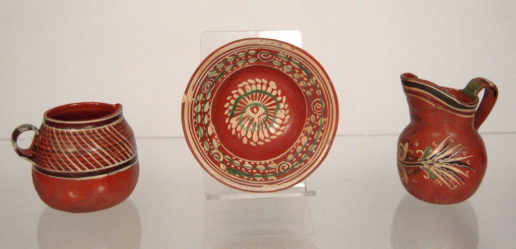 3 pieces of vintage, hard-to-find Mexican 'bandera' pottery, consisting of  a creamer, small jug and bowl hand potted and painted with floral and geometric designs. 'Bandera' pottery is so named because the colors (red, white and green) evoke the