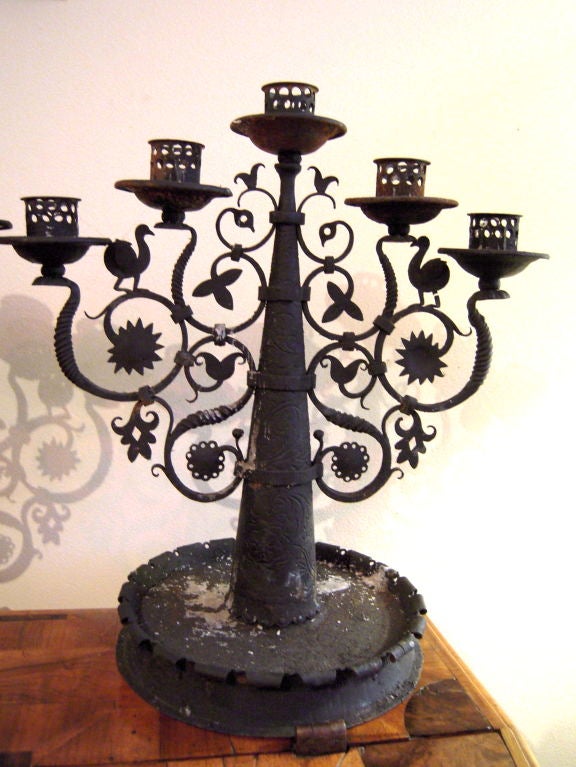 Pair of finely crafted 5-light wrought iron candelabra, with stylized floral, foliate, sun and bird decoration. <br />
Provenance: A. Piatt Andrew's home, 