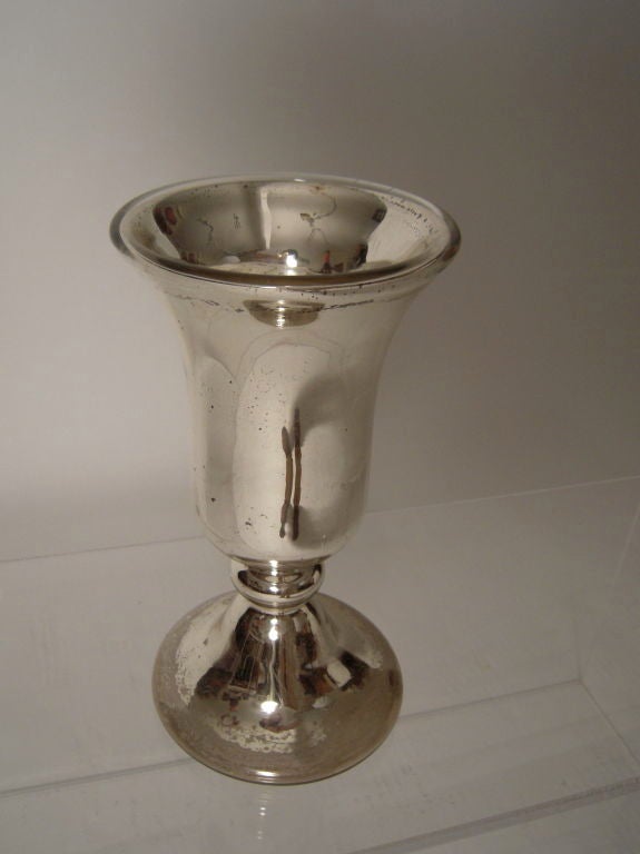 A tall 19th century mercury glass vase of inverted bell shape on a spreading trumpet form base. Mercury glass is double walled glass with silver nitrate (not mercury) between the layers. Less expensive at the time and with softer edges, it was