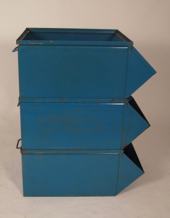 4 individual blue enameled metal stacking industrial bins. Versatile for storage horizontally or vertically. Would be great in a kitchen, mudroom, family room or children's room. They can also be topped with glass for a coffee table. Sold