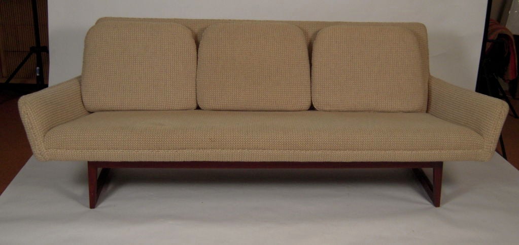 A Jens Risom designed sofa with flared arms and three loose back cushions raised on a rectilinear hardwood base. Very comfortable.<br />
<br />
Jens Risom is one of the most significant mid century designers and among the first to introduce