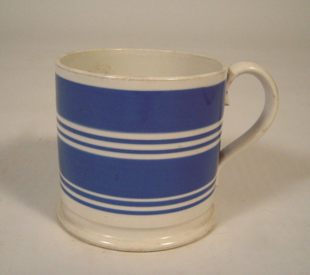 A large English Staffordshire mug with, the white body decorated with thick and thin cobalt blue bands.