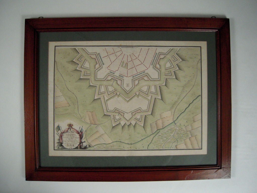 A bold geometric architectural pen and ink and watercolor drawing of an English star-shaped fortification, signed 'John Cummins' and dated 1782 lower left and dedicated to Lord Amherst in a flag, cannon and crown trophy. Framed.

This drawing is