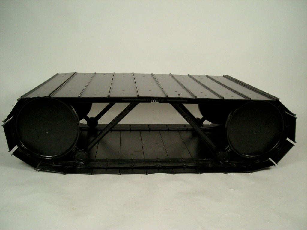 A rolling 'tankette' table designed by Paolo Pallucco and Mirielle Rivier, in anodized aluminum with articulated rectangular metal plates on aluminum wheels with spring suspension. <br />
<br />
This table has been featured in museum exhibitions