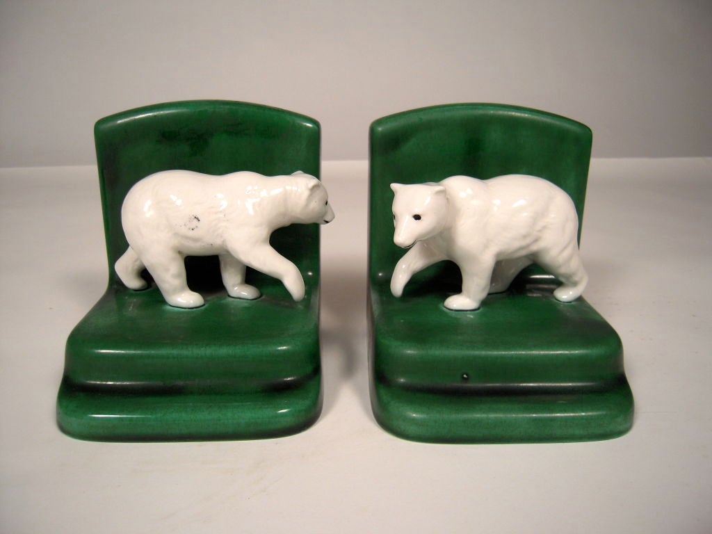 A pair of green and white glazed ceramic polar bear bookends