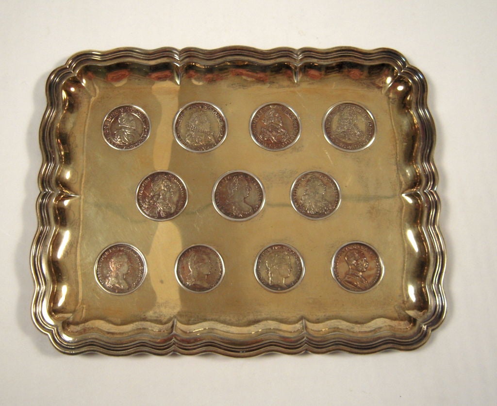 An unusual European silver gilt tray of rectangular form with serpentine edges,  inlaid with a collection of Austrian, Hungarian and Bohemian coins depicting various heads of state from the Holy Roman Empire.