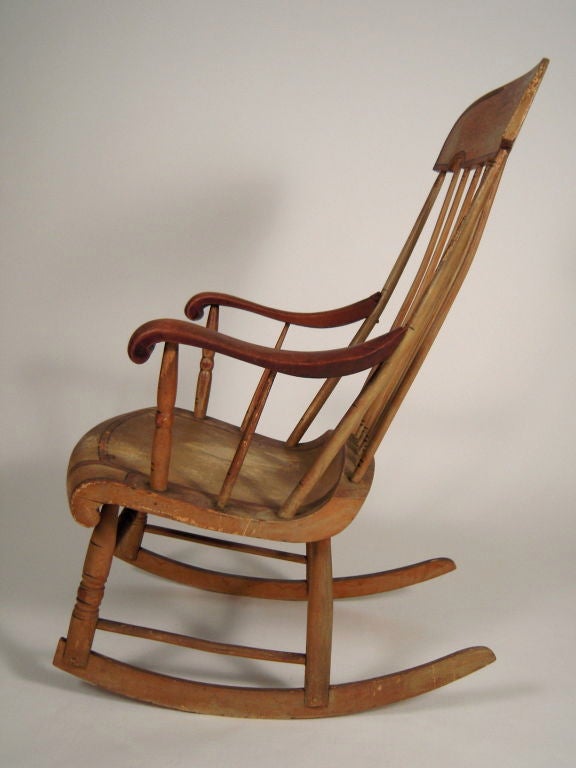 A 19th century American country rocking chair, in original ochre paint with contrasting red/brown and black painted decoration, the arms in natural unpainted state. Generously proportioned and comfortable.