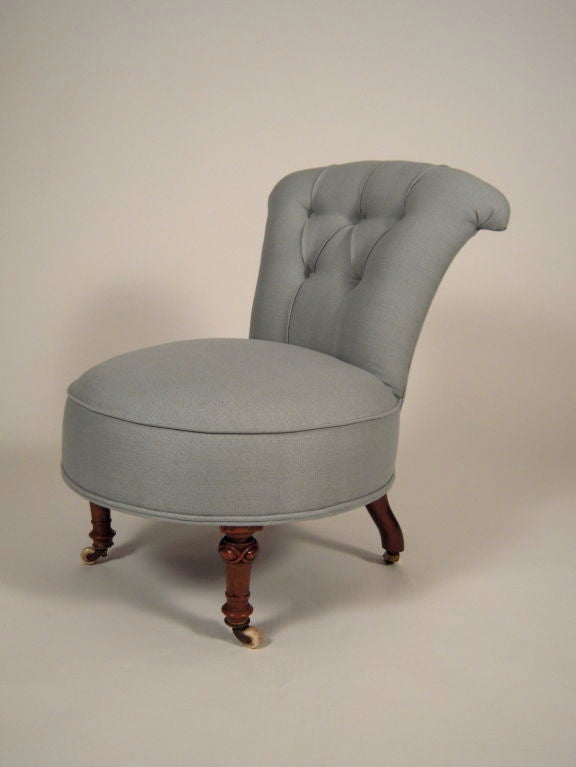 A diminutive, yet very comfortable 19th century slipper chair with carved walnut legs, newly restored and reupholstered in light blue linen. Perfect in a bedroom or small seating area.