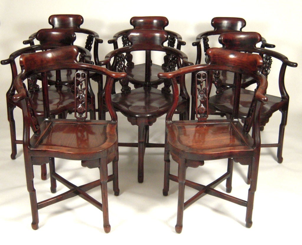 A rare set of 8 Chinese carved and well joined solid rosewood or hong mu wood (a Chinese reddish hardwood) dining chairs, with curved backs supported by carved flower-in-vase back splats, 2 with inset panel seats and slightly different back splats,