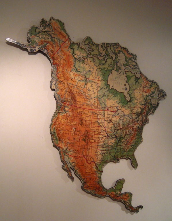 A vintage schoolroom map of North America newly mounted on heavy duty masonite with reinfocements on back for easy hanging, and cut along the perimeter of the continent's boundaries, making it interesting and stylish sculptural wall decoration.