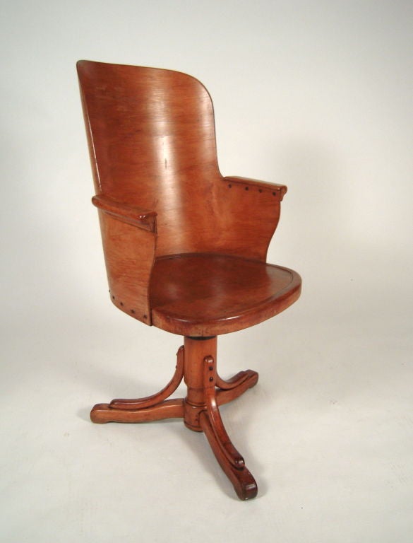 A stylish, unusual (and comfortable) bentwood office chair the tall curved back with arm rests  attached to a conforming adjustable height seat raised  on bentwood tripod base.