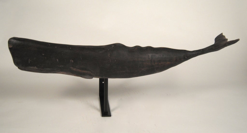 A well carved and painted wood figure of a sperm whale, together with bracket for wall mounting.<br />
<br />
On wall bracket: 10 1/2