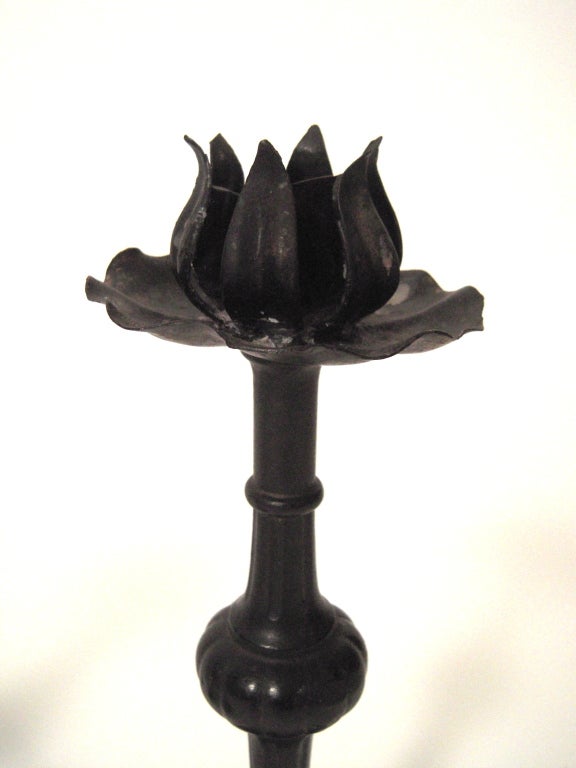 Pair of Gothic Revival cast and wrought iron candlesticks, 19th century, each with floriform sconce and drip cup over knopped, fluted, and beaded stem, on flared, spreading quatrefoil foot.
