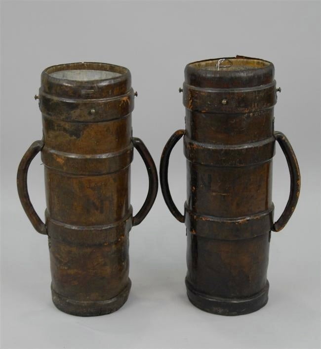 A PAIR OF ANTIQUE ENGLISH MILITARY CANNON POWDER ARTILLERY BUCKETS IN LEATHER WITH ZINC LINED INTERIORS, circa 1750-1820.

These would make excellent umbrella stands, planters or decoration in a hall way or flanking a fireplace, among other