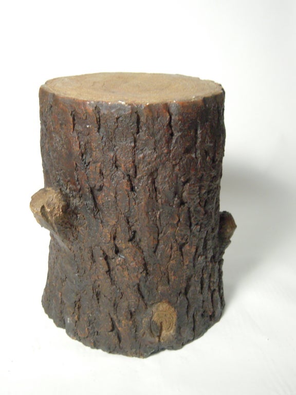 A naturalistically  modeled tree trunk occasional table, stool or pedestal in cast and colored resin, stylish and superior to the real wood in terms of durability and weight. Likely made as a theatrical prop or store display item.