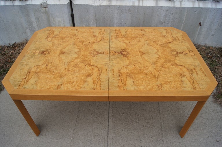 The stunning grain of the burled wood veneer makes this table a work of art. The wide angled legs add unique presence.

This table includes two leaves, each of which measure 19.25