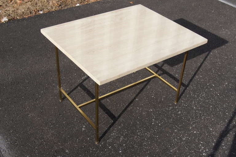 Designed by Paul McCobb for Directional, this end table is composed of a rectangular travertine top and a brass base. A corresponding sectional sofa with travertine corner table is also available.
