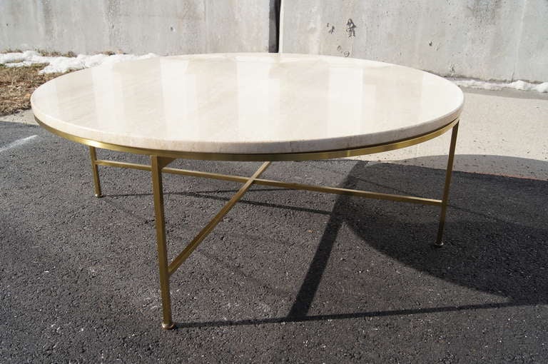 Designed by Paul McCobb for Directional, this coffee table is composed of a round travertine top and a brass base. This table is part of a set that includes a sectional sofa with a travertine corner table and a travertine end table.
