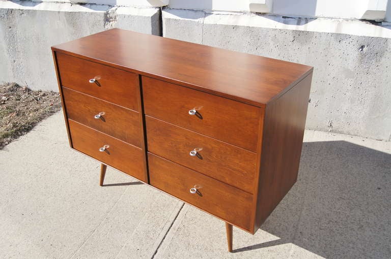 This dresser was designed by Paul McCobb for Winchendon Furniture's Planner Group line. It is composed of a six-drawer case piece that sits atop a detached platform base (see pictures). The dresser has been expertly refinished and features the