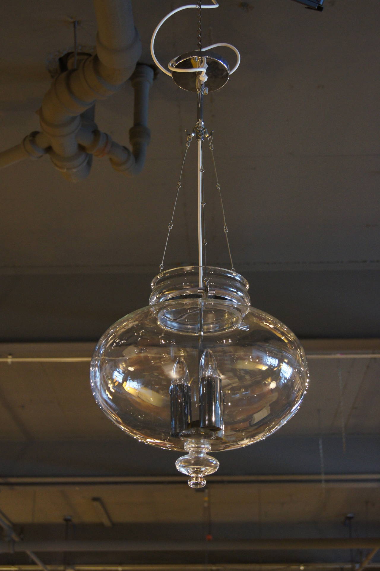 This hanging lamp was manufactured by Glashütte Limburg in Germany. It is composed of blown glass with three chrome light fixtures. Original tag is intact.