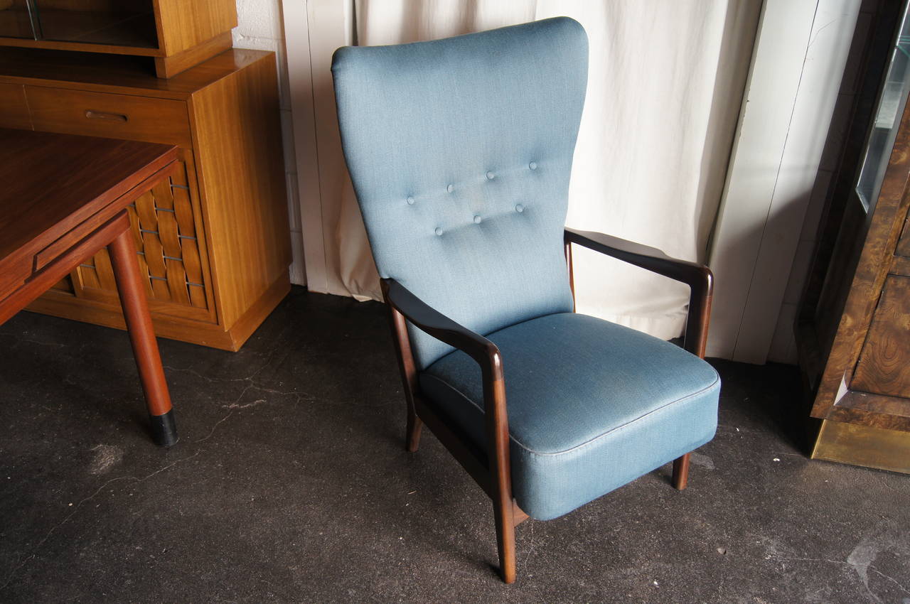 This rare lounge chair is upholstered in blue textile. The frame is able to be completely disassembled without any tools.