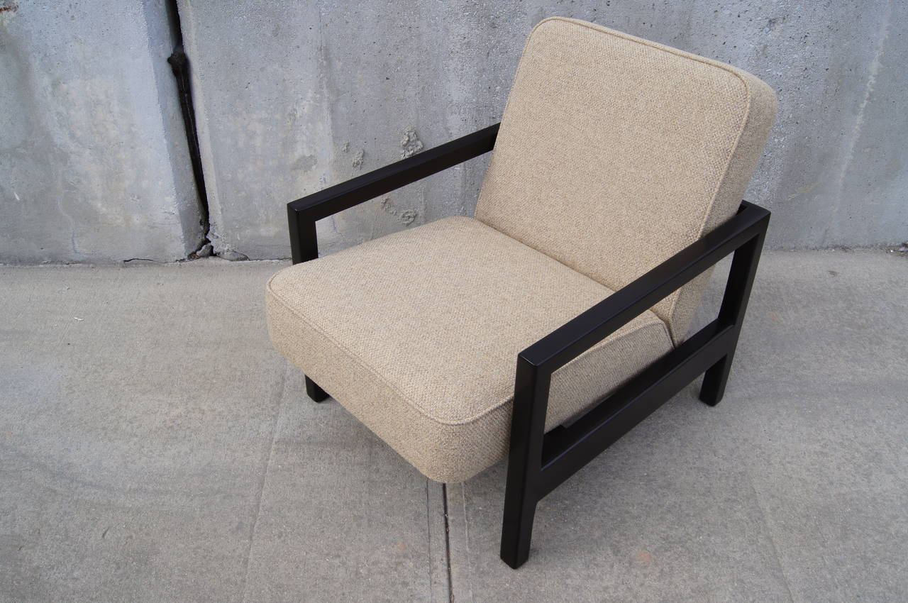 Designed by George Nelson for Herman Miller, this rare lounge chair, model 4774, features an open ebonized birch frame. Its strong rectangular lines accent the angled cushioning of the seat and back. The chair has been reupholstered in Knoll's Ferry