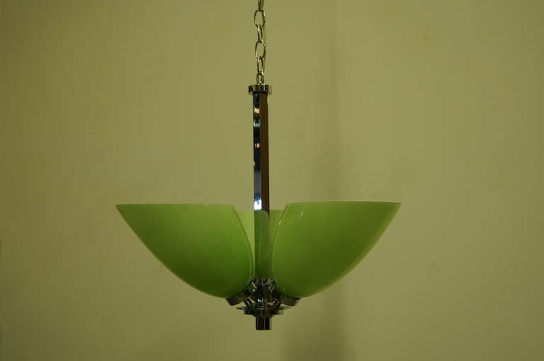 Suspended from a chrome frame, this Italian ceiling lamp features a trio of jade-green glass shades that direct light upward in a chartreuse glow. Each angled shade is approximately 7 inches tall.